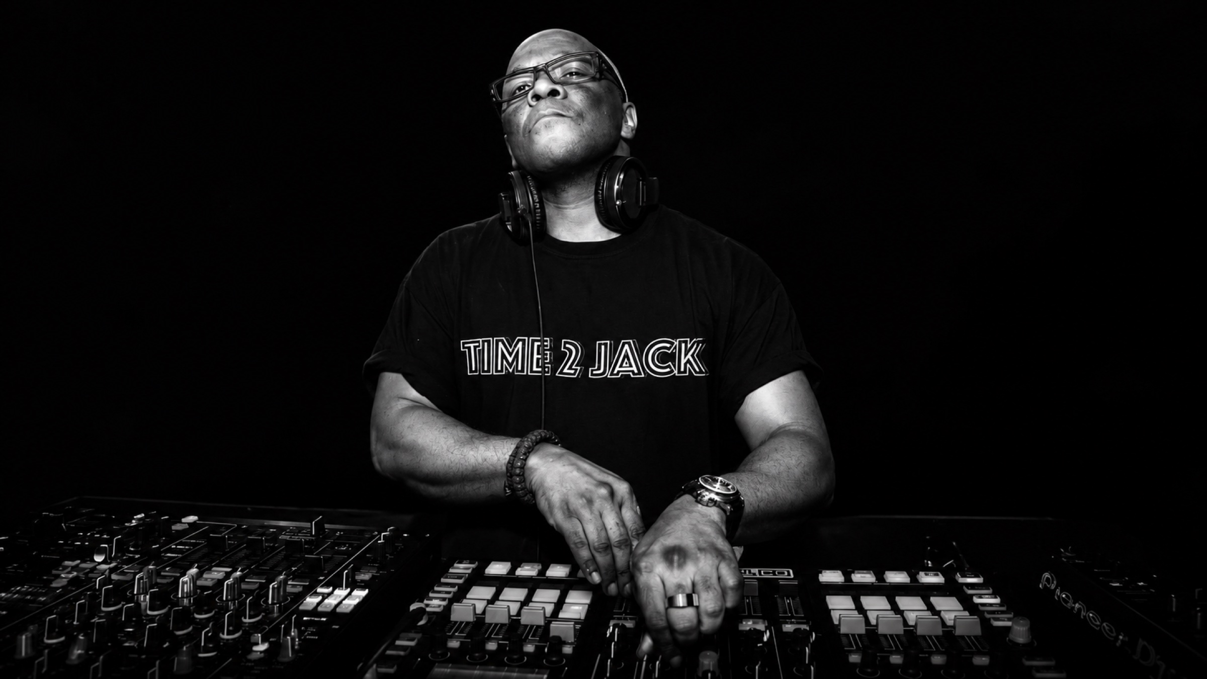 Chip E. behind the decks in a Time 2 Jack shirt